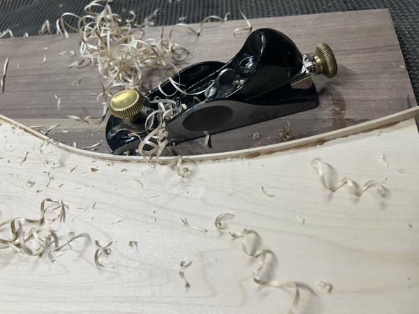 Planing the glued maple strip using a small low-angled block plane.